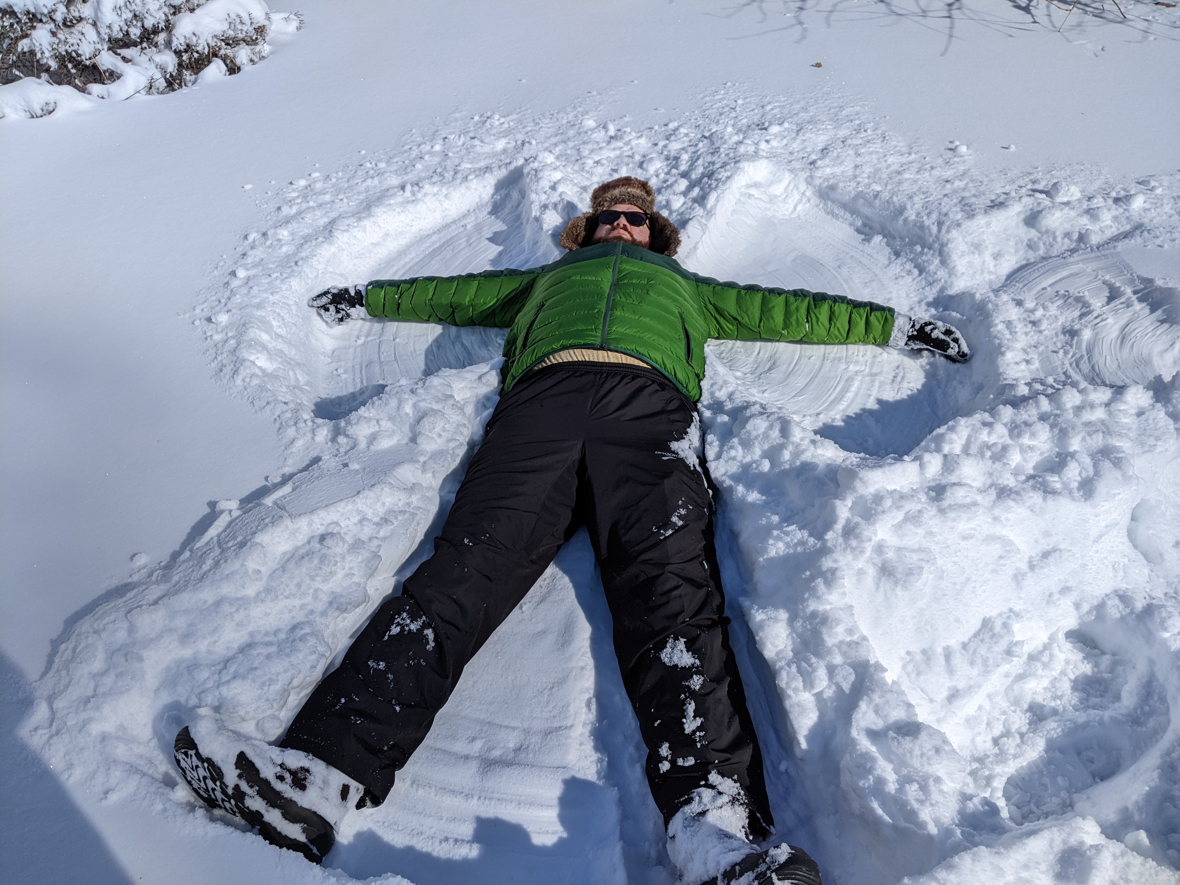 The author, still in snow angel position, arms in a 