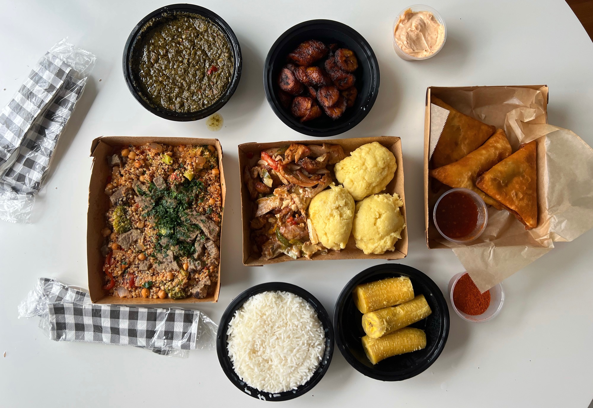 On a white table, the author's lunch is uncovered revealing various African dishes. Photo by Alyssa Buckley.