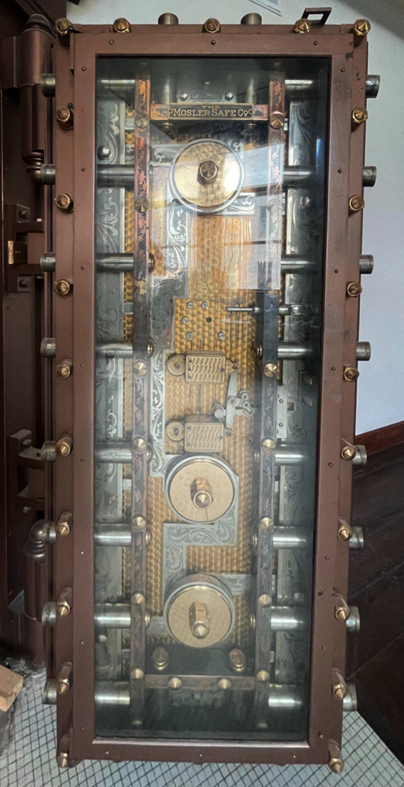 The interior of a door to a former bank vault. It has gold and steel in workings and bolts. Photo by Andy Long.