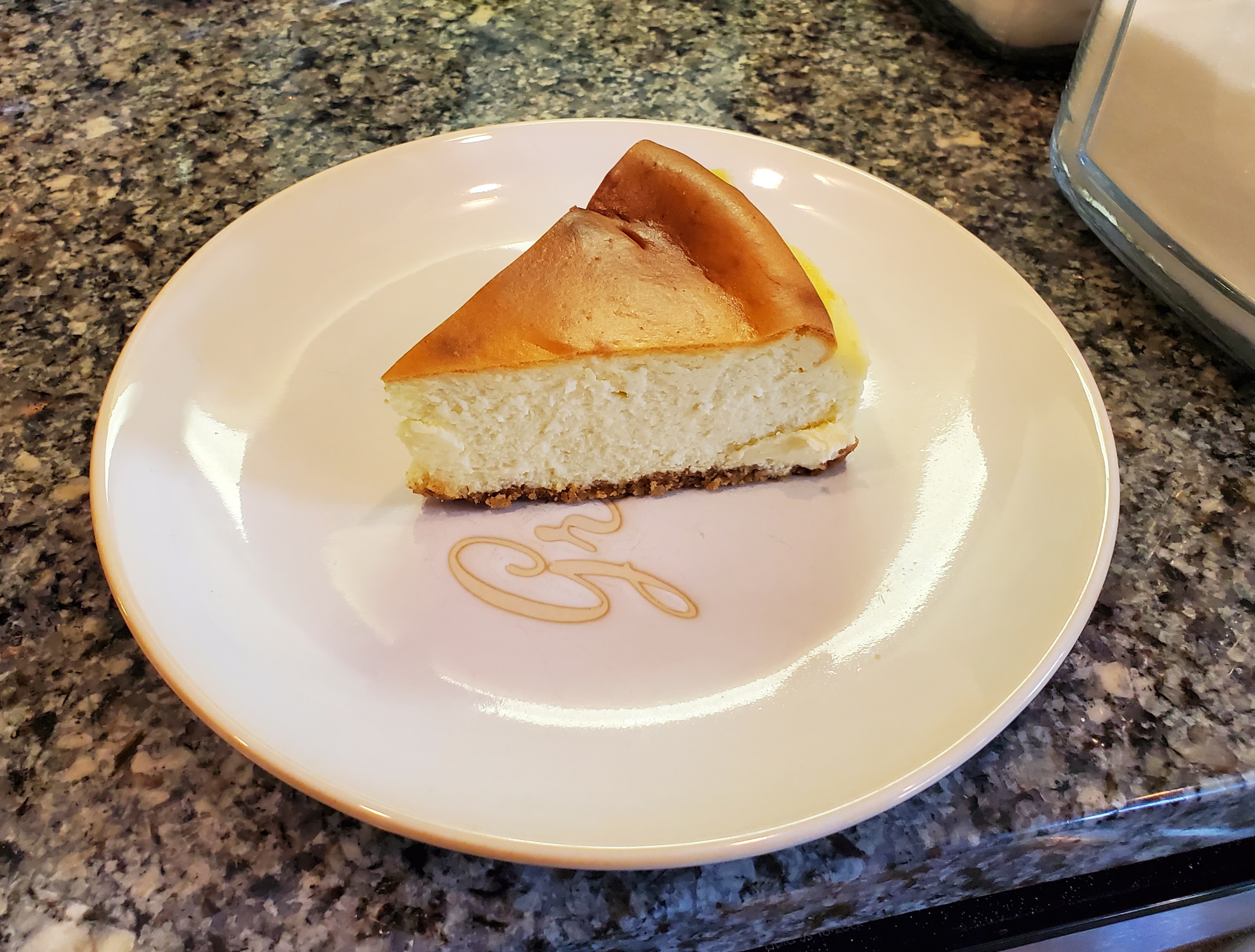 On a white plate, there is a NY cheesecake. Photo by Carl Busch.
