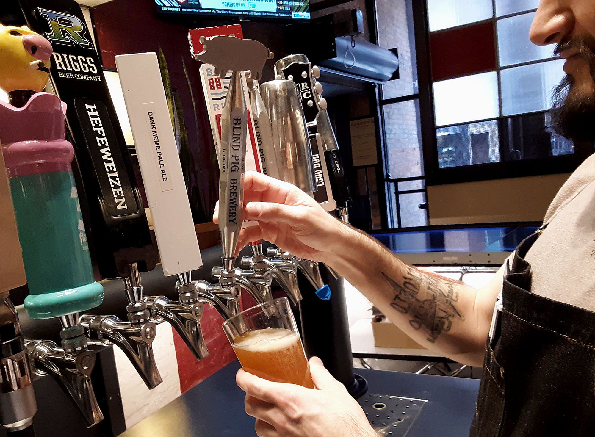 Terry Boyer at Farren's Pub pours beer from a draft tap. Photo by Paul Young.