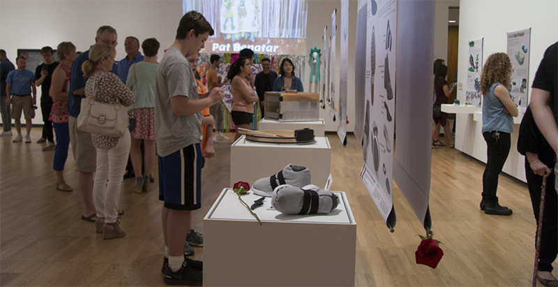 Photo of students and community members gathering at a student art exhibition at Krannert Art Museum.
