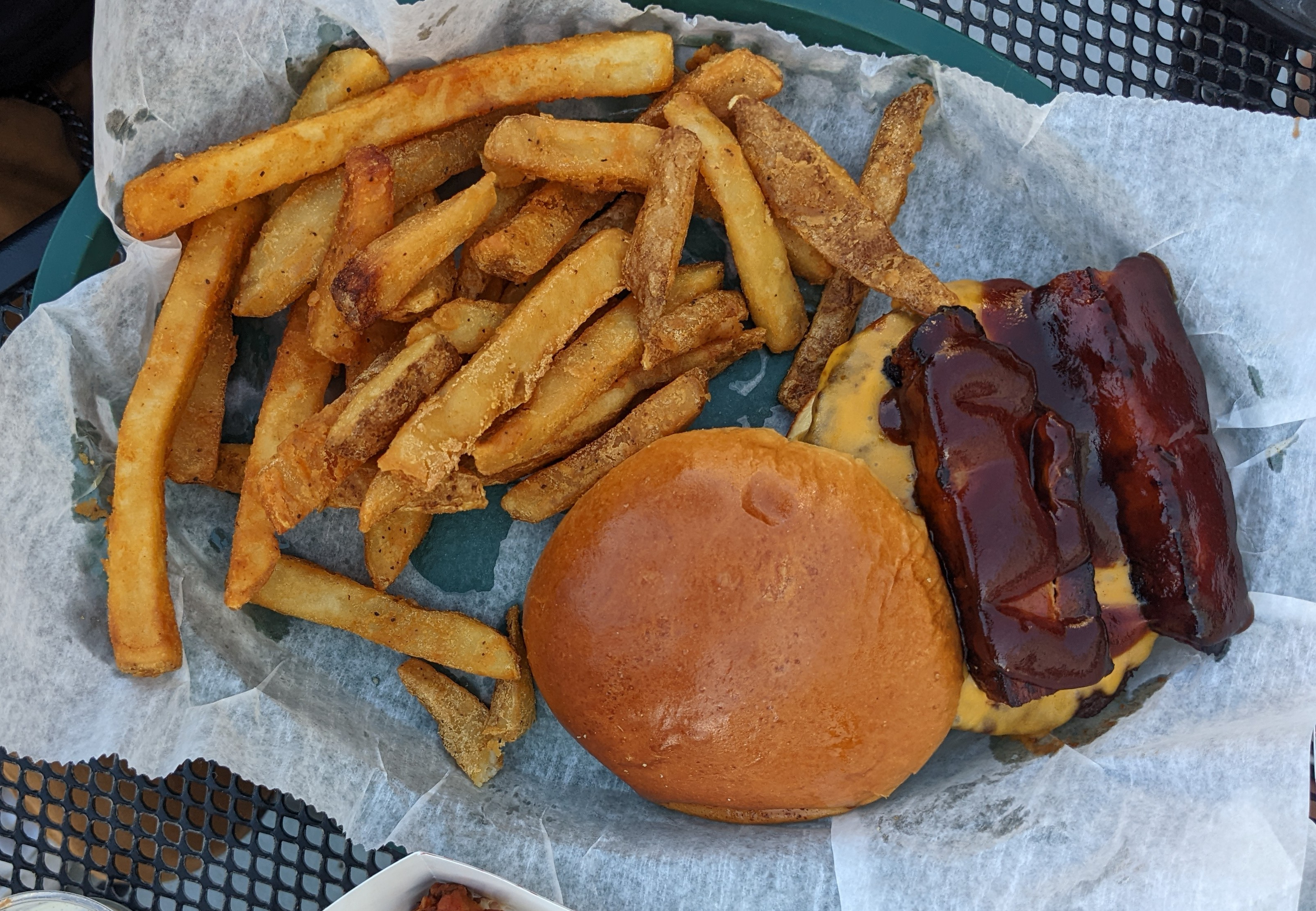 An overhead photo shows Bunny's porker with a side of fries on an outdoor table at Bunny's. Photo by Tayler Neumann.