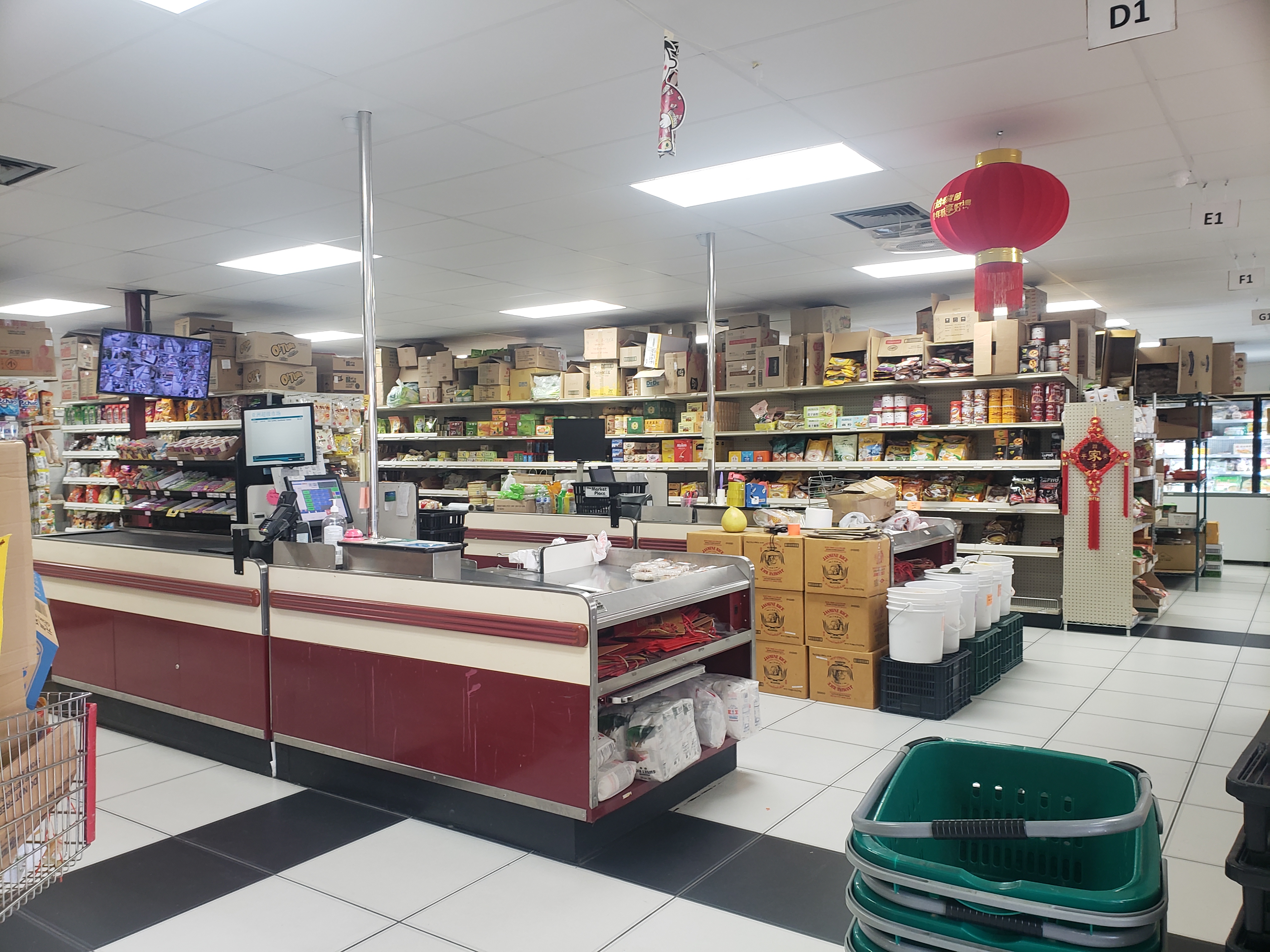 Inside Asian Supermarket on North Prospect in Champaign, there is a brightly lit store with a simple belt at check out. Photo by Elisabeth Paulus.