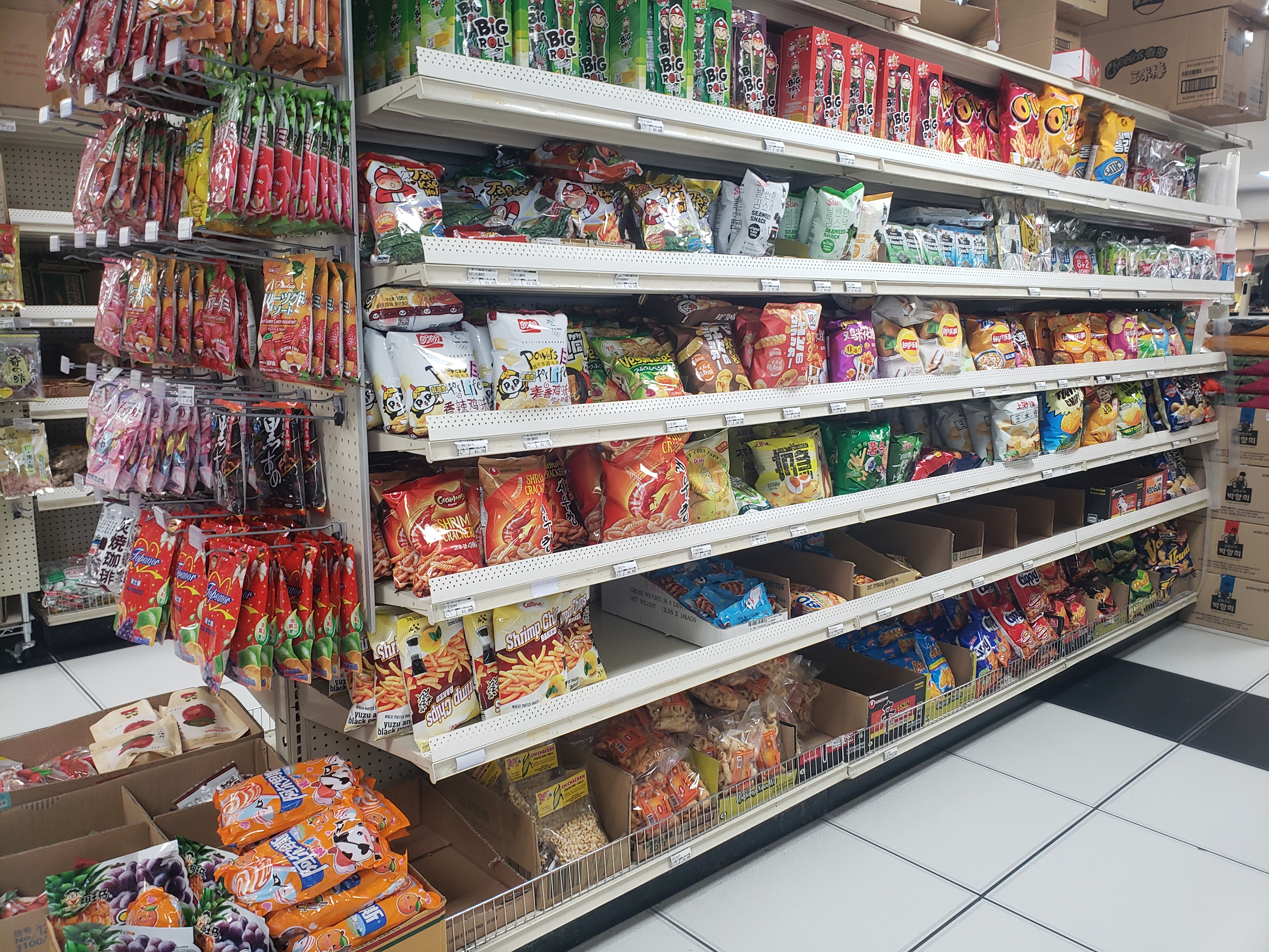 Inside Asian Supermarket, there are shelves of Asian snacks in bags. Photo by Elisabeth Paulus.