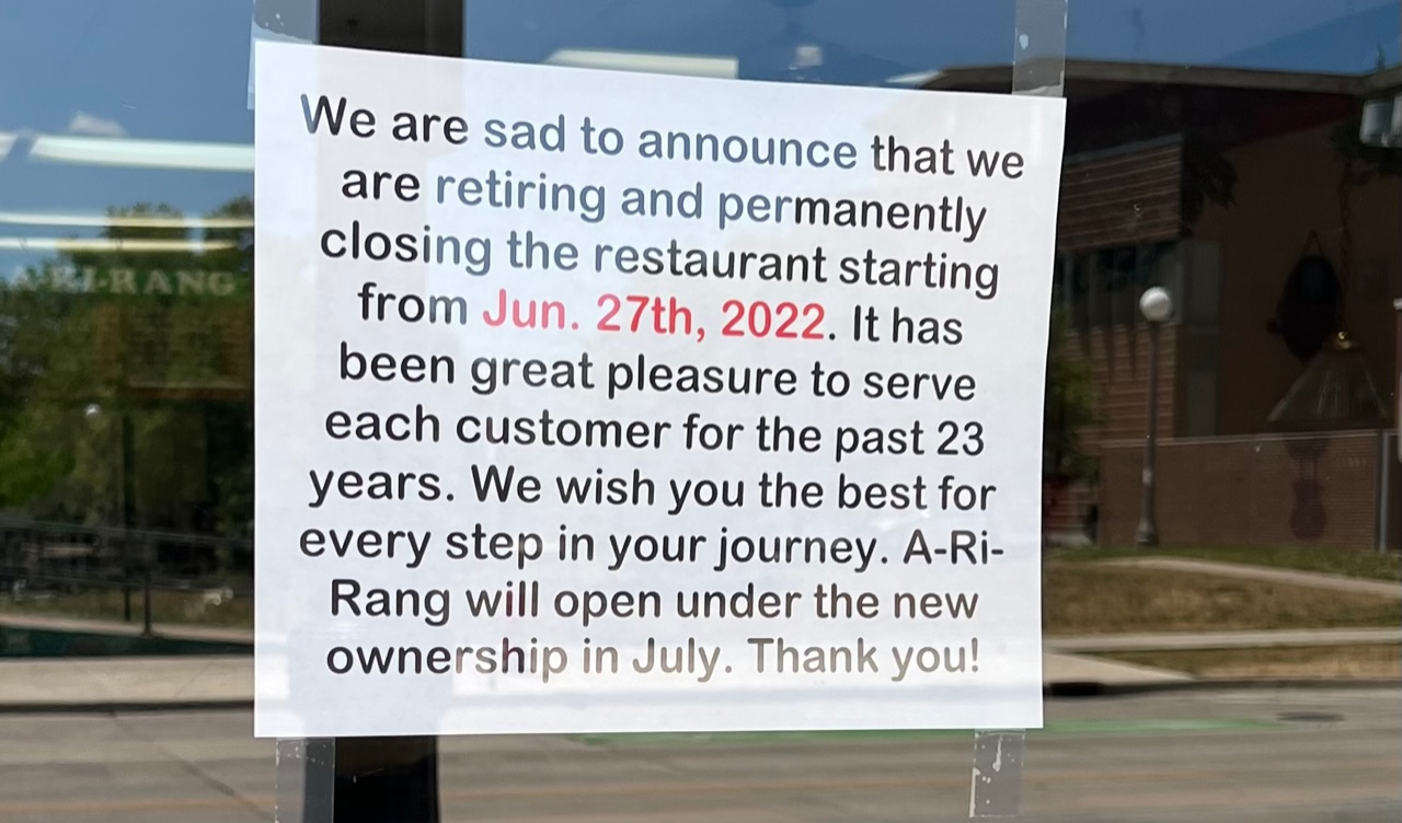 A white piece of paper with a typed message reads a closure announcement from A-Ri-Rang in Champaign. Photo by Seth Fein.