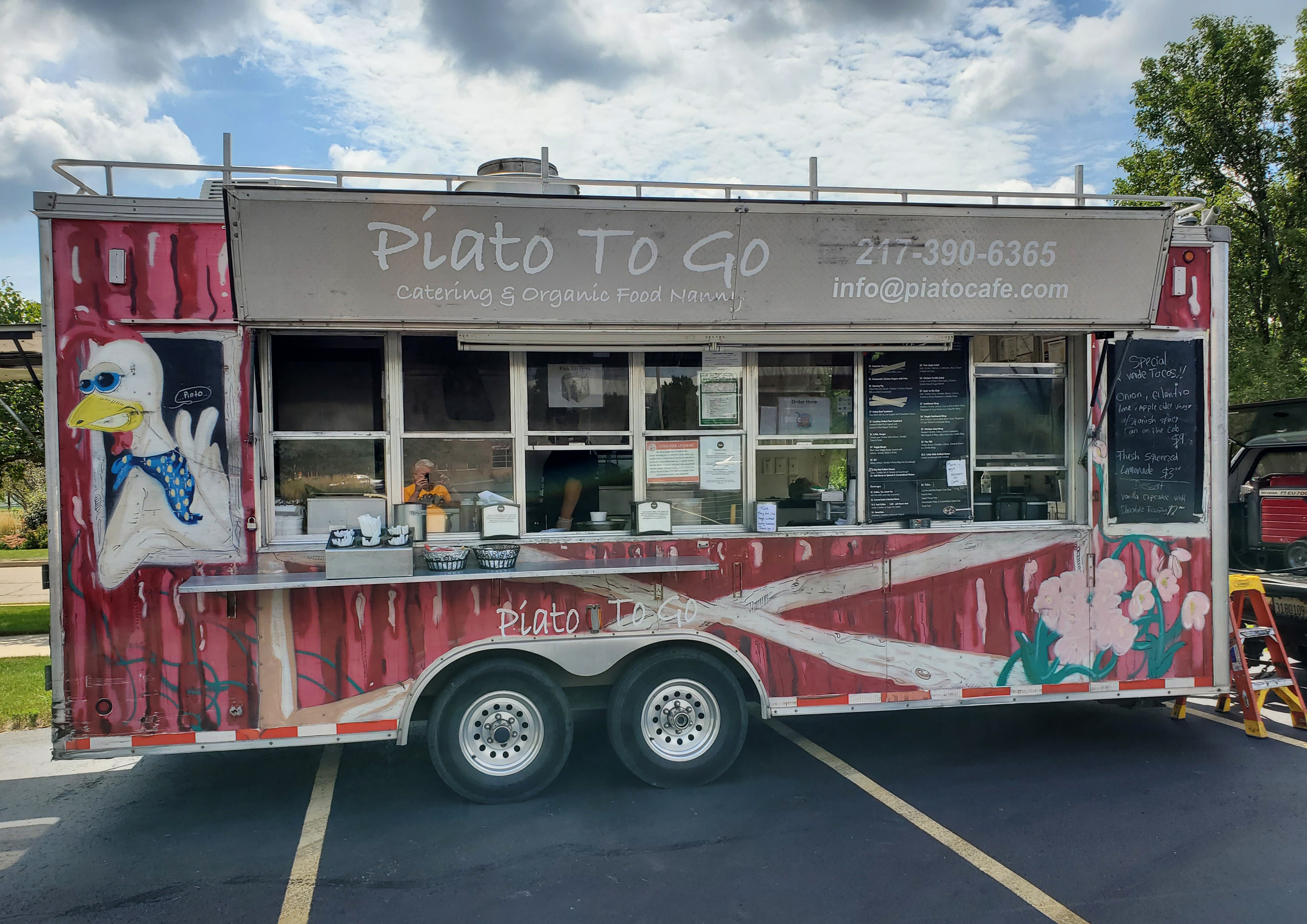 A red food truck with a chicken on the side giving a peace sign is for the Piato To Go Food Nanny. Top image by Carl Busch.