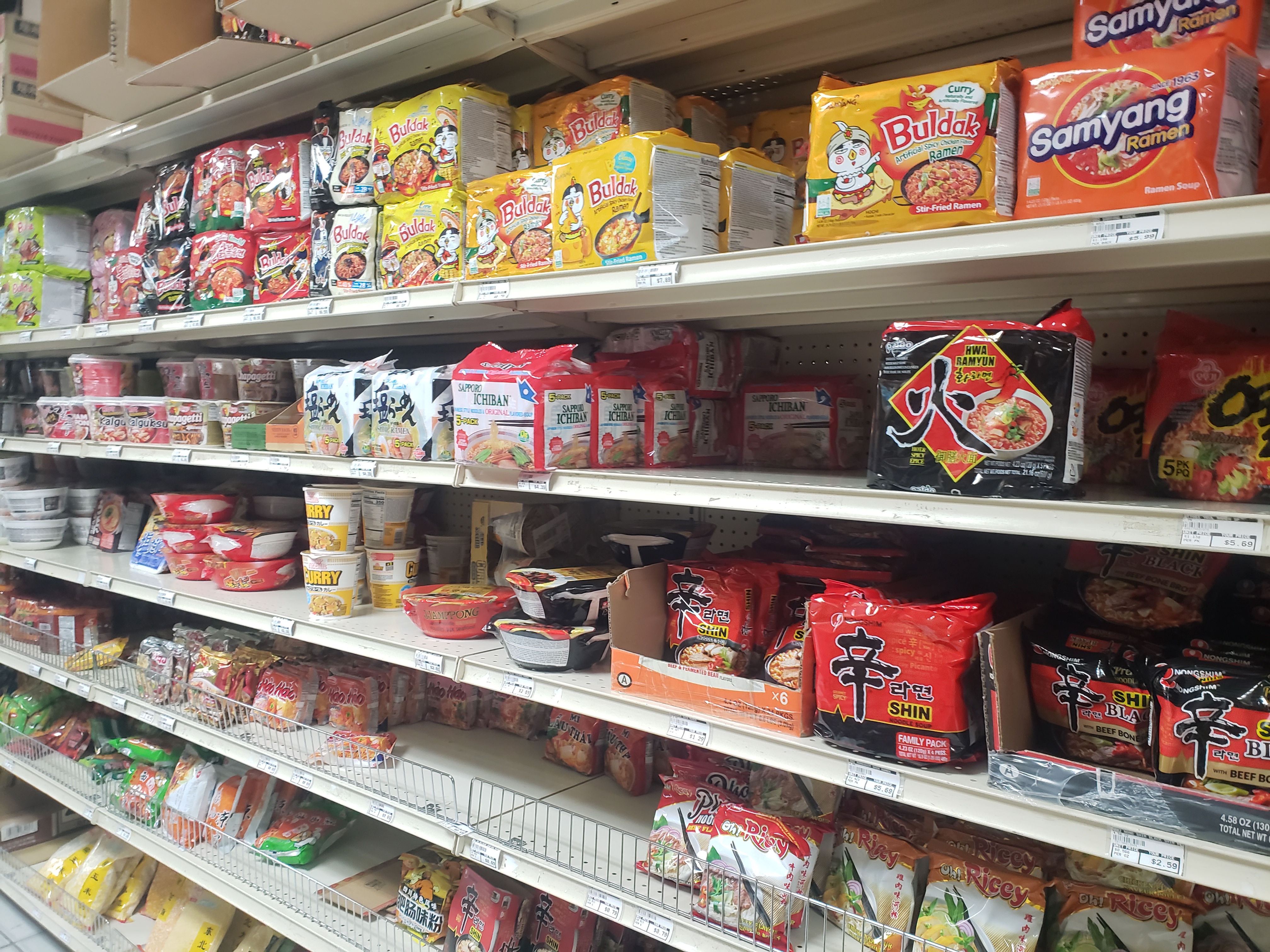 On white shelves in Asian Supermarket, there are breads and noodle options. Photo by Elisabeth Paulus.