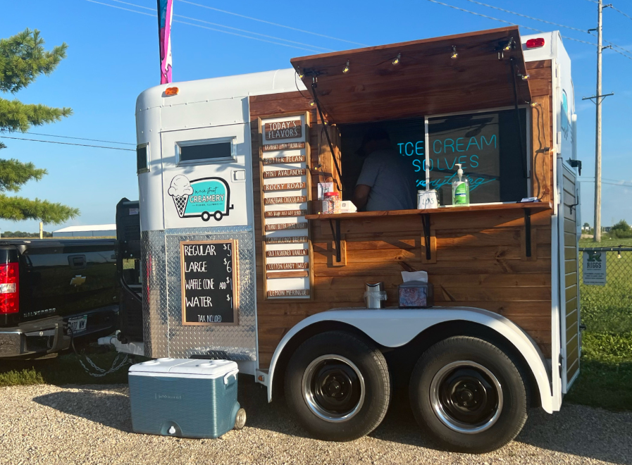 Main Street Creamery's trailer with wood paneling and a white top sells ice cream at Riggs in Urbana. Photo by Alyssa Buckley.