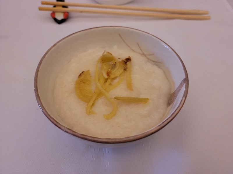 Jok with thick fresh ginger slices resting on top of the porridge. Photo by Matthew Macomber.
