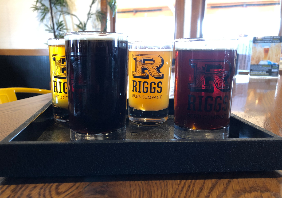 On a square black tray, there are four beers at Riggs Brewing Company in Urbana. Photo by Jesus Barajas.