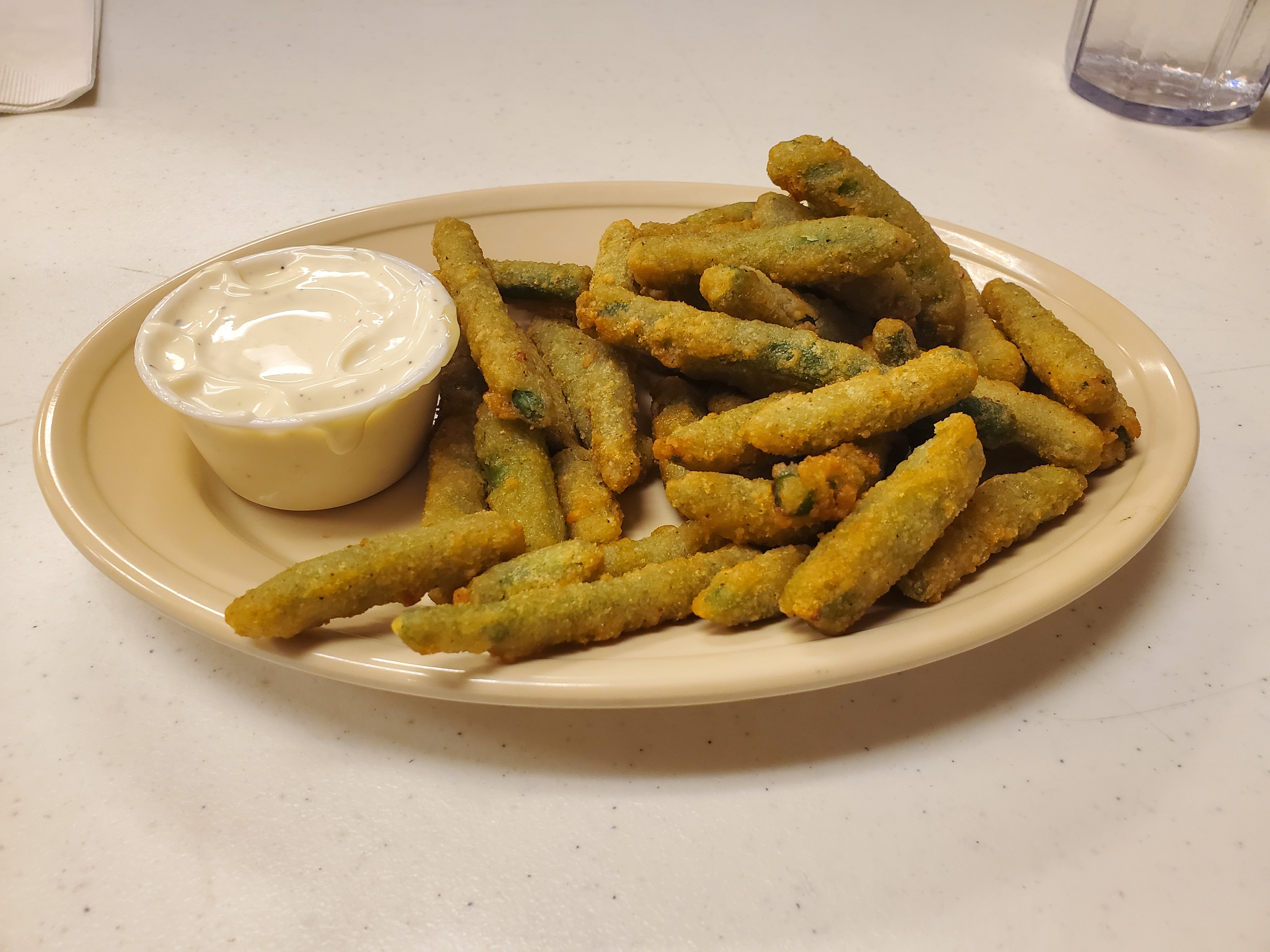 A plate of fried green beans and a side cup of ranch. Photo by Carl Busch.
